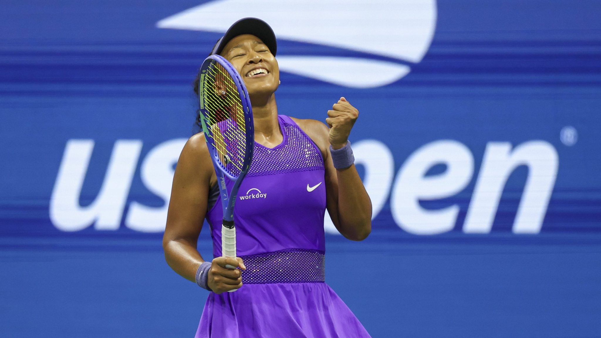 Naomi Osaka pumps her fist and celebrates