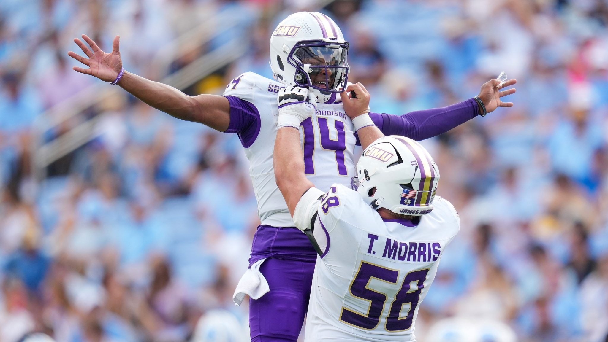 Alonza Barnett III #14 celebrates with Tanner Morris #58 of the James Madison Dukes after throwing for a touchdown against the North Carolina Tar Heels