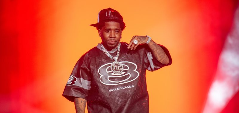 Rapper YFN Lucci performs on stage, wearing a black Balenciaga jersey