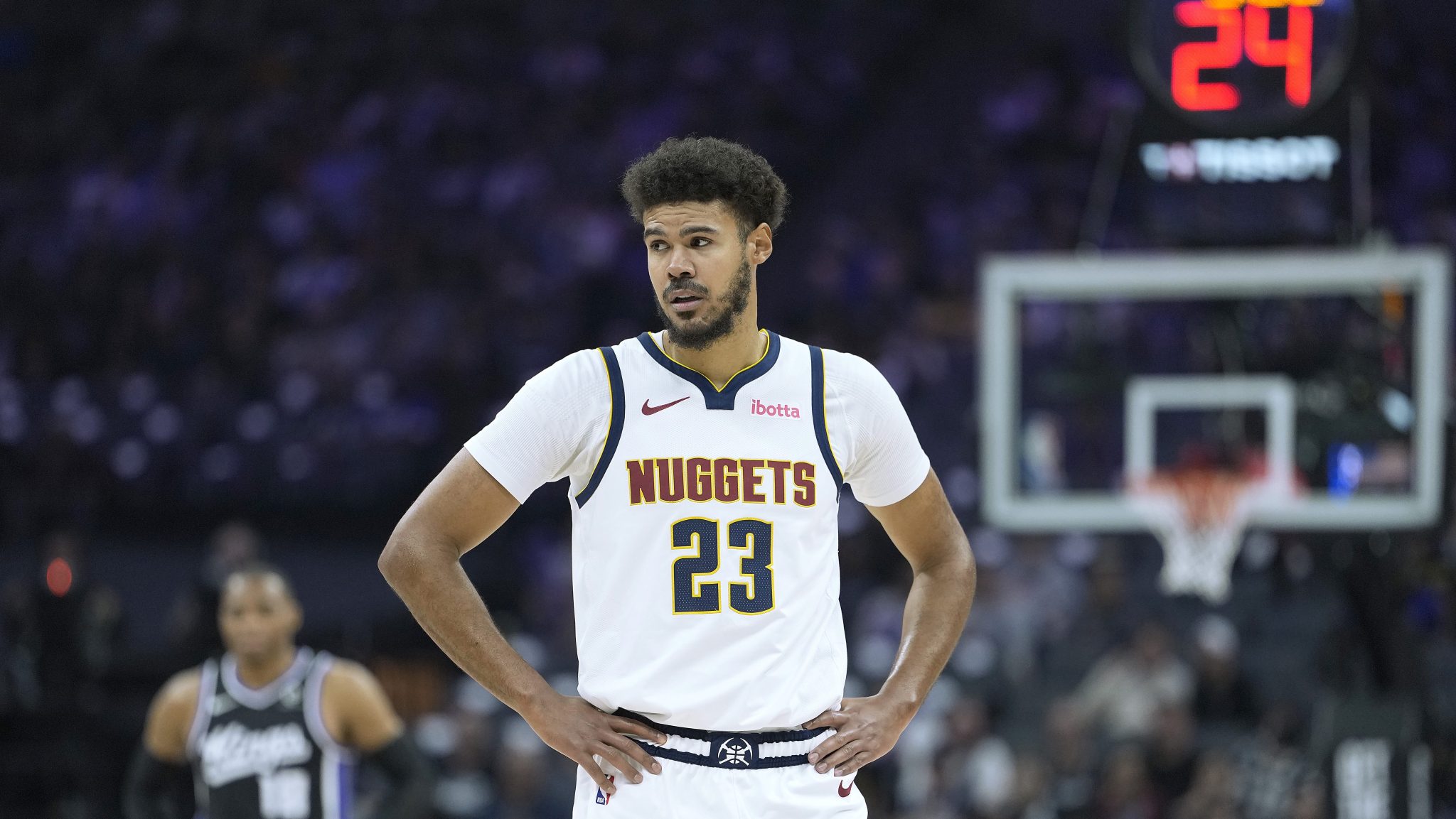 Cameron Johnson stands on the court with his hands on his hips during a break
