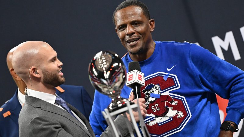 ESPN's Harry Lyles (left) interviews South Carolina State head coach Chennis Berry after Berry's Bulldogs defeated Prairie View A&M 40-38 at the Celebration Bowl on Dec. 13, 2025, at Mercedes-Benz Stadium in Atlanta.