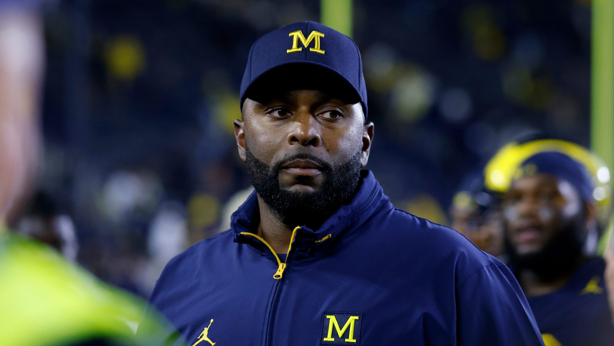 Coach walking off football field