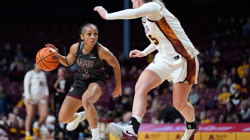 Alabama A&M guard Vanessa Wimberly (left) works toward the basket against Minnesota forward Grace Grocholski (right) on Dec. 10, 2025, in Minneapolis.