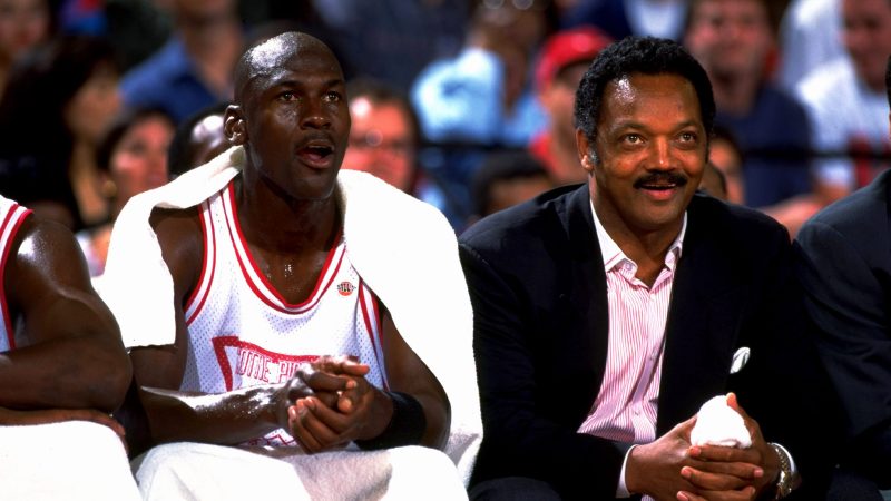 Michael Jordan on the bench with Reverend Jesse Jackson in 1994