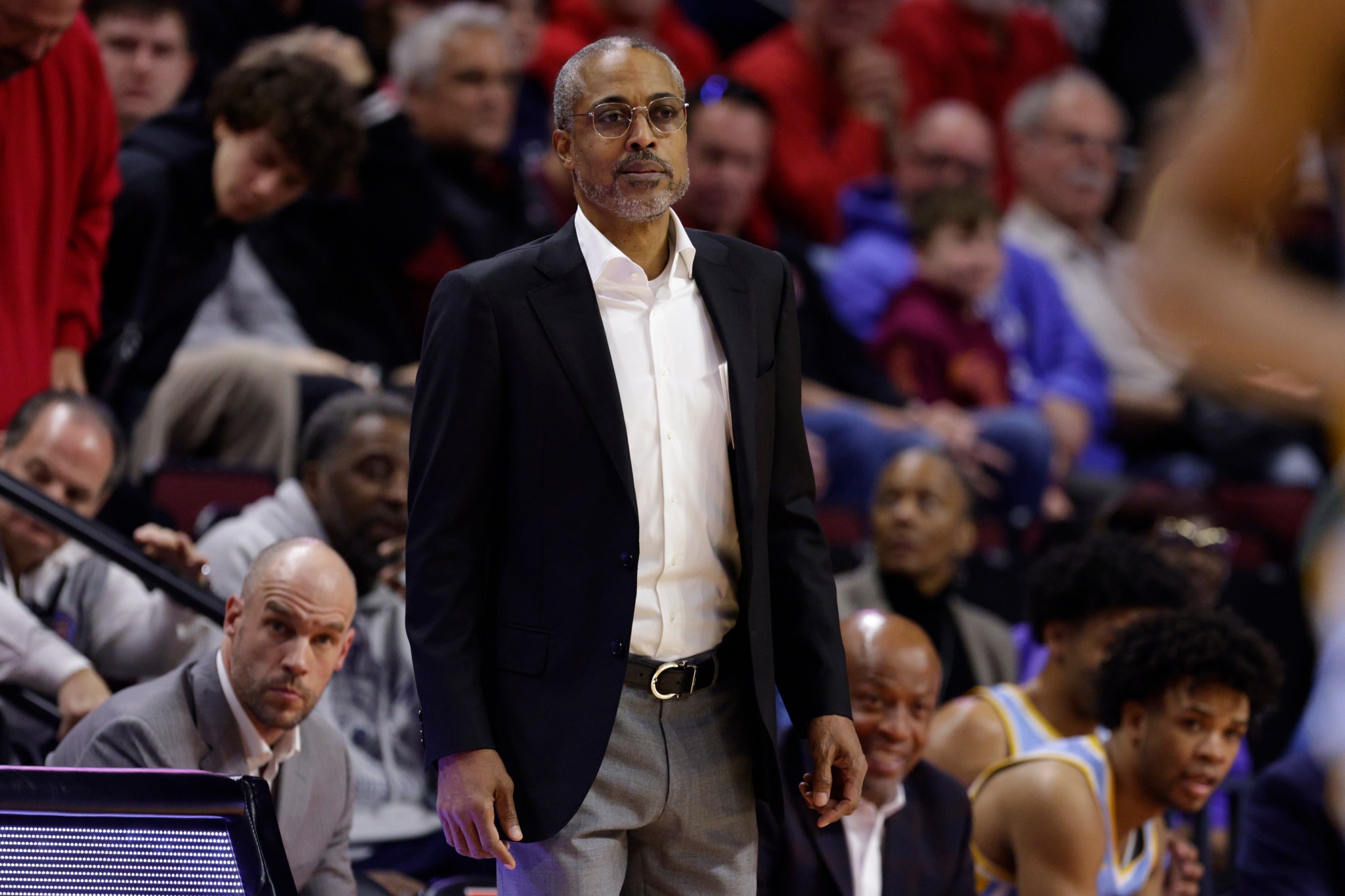 Rod Strickland watches the game from the sidelines.