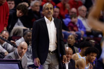 Rod Strickland watches the game from the sidelines.
