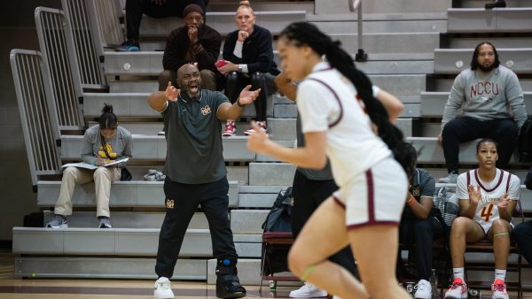 Bishop McNamara head coach, Ron James yells for his team to get back on defense while playing Duncanville High School at the AMS Capital Invitational at Sidewell Friends High School on December 7, 2023, in Northwest Washington, DC