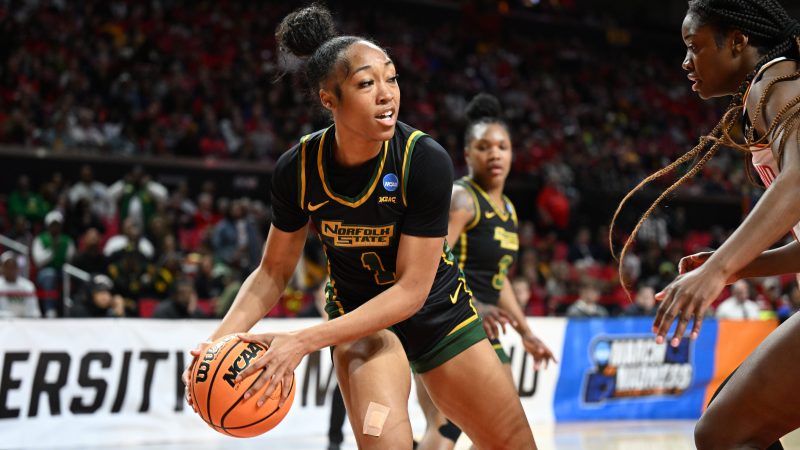 Norfolk State player Da'Brya Clark (center) looks to pass the basketball during a first-round NCAA tournament game on March 22, 2025, at Xfinity Center in College Park, Maryland.