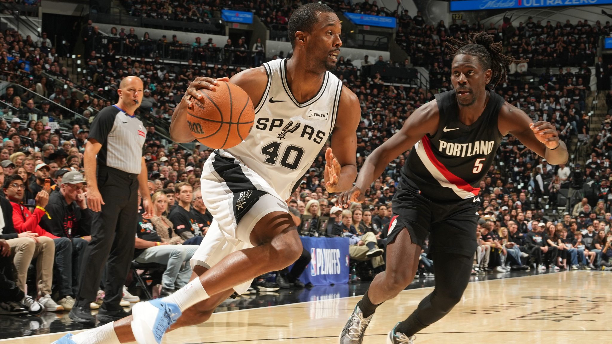 Harrison Barnes dribbles the ball past a defender.