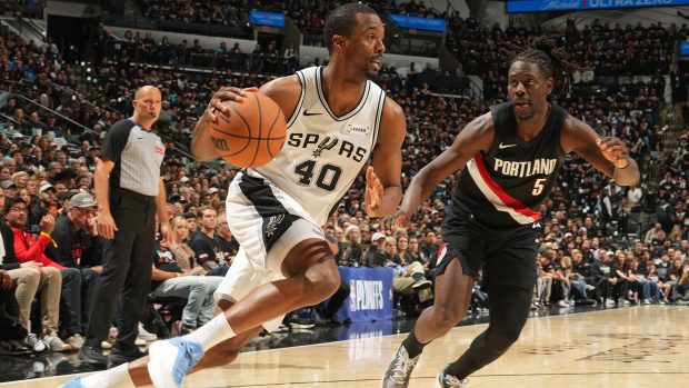 Harrison Barnes dribbles the ball past a defender.