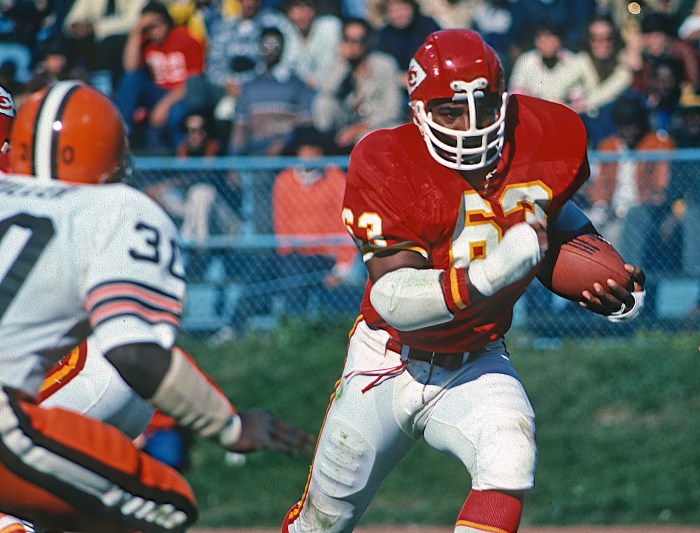 Willie Lanier (right) of the Kansas City Chiefs runs with the football during a game against the Cleveland Browns on Oct. 30, 1977, at Cleveland Municipal Stadium in Cleveland.