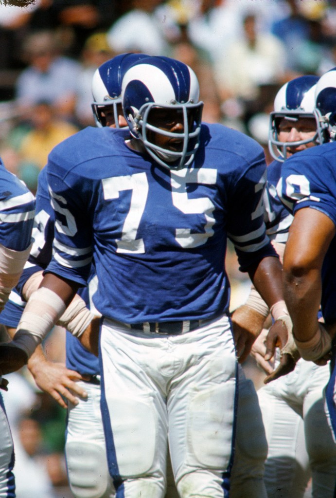Deacon Jones (center) of the Los Angeles Rams looks on during a game against the Dallas Cowboys circa 1962 at Los Angeles Memorial Coliseum in Los Angeles.