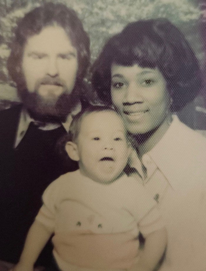 Trajan Langdon as a baby with his parents.