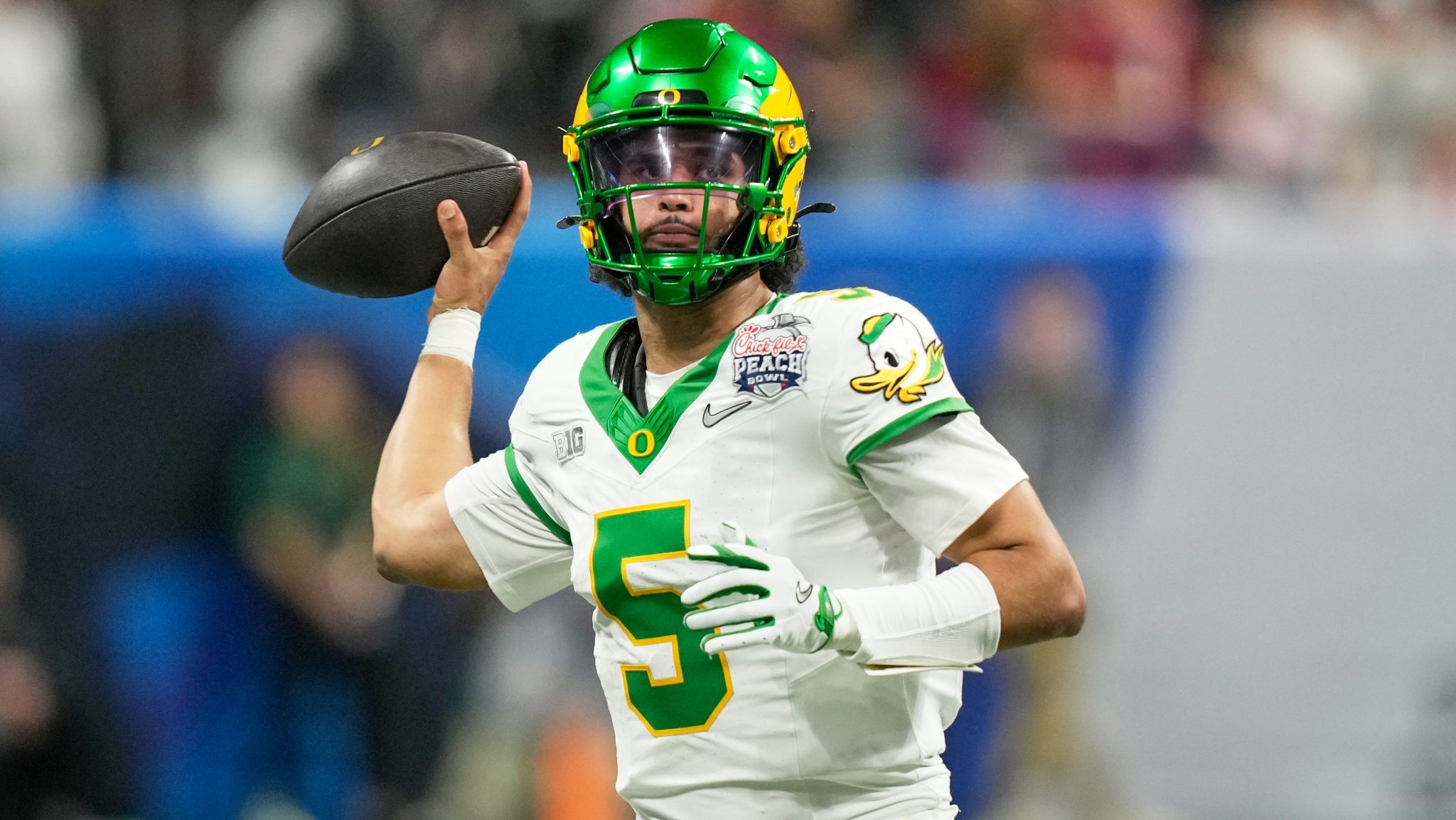 Dante Moore throws the ball.