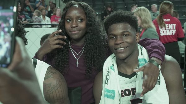 Raven Johnson (left) and Anthony Edwards (right) take photos after one of his games at the University of Georgia in 2019.