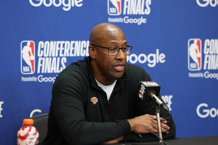 Coach Mike Brown talks to the media during a press conference.