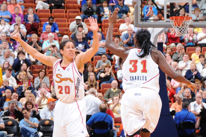 Kara Lawson (left) high-fives Connecticut Sun teammate Tina Charles (right) during a game against the Minnesota Lynx on May 27, 2010, at the Mohegan Sun Arena in Uncasville, Connecticut. 