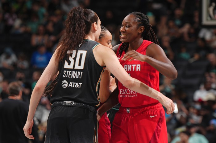 Former teammates Breanna Stewart (from left) of the New York Liberty and Tina Charles of the Atlanta Dream before their game on June 30, 2024, at Barclays Center in Brooklyn, New York. 