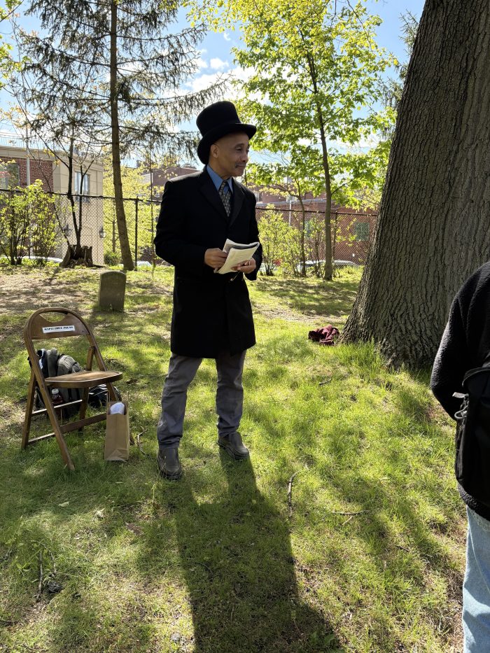 Poet David Mills performs at Maple Grove Cemetery