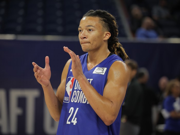 Kingston Flemings claps his hands while watching the NBA draft combine.