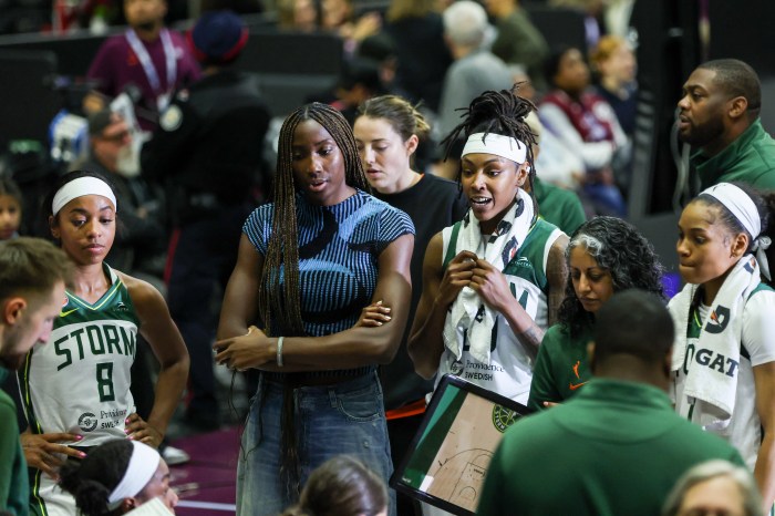 Seattle Storm players Lexie Brown (from left), Ezi Magbegor and Jordan Horston discuss team strategy with head coach Sonia Raman and guard Zia Cooke during a game against the Toronto Tempo on May 13, 2026, at Coca-Cola Coliseum in Toronto.