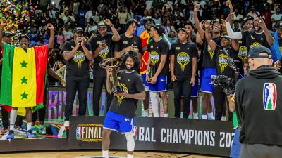 RSSB Tigers' players celebrate and hold the BAL trophy after winning the final game.