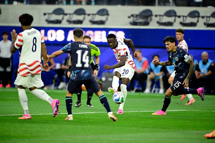 Folarin Balogun (center) kicks the ball