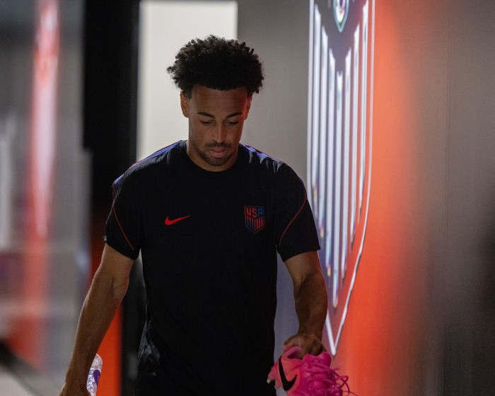 Tyler Adams walks to the field before practice