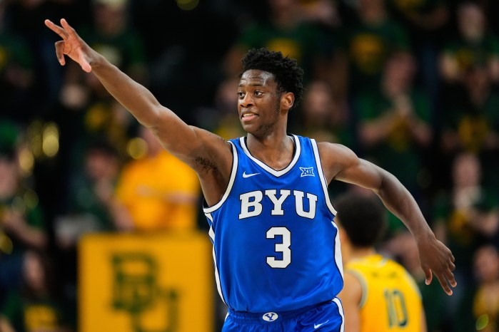 AJ Dybantsa celebrates his three-pointer by pointing his right arm up in the air.