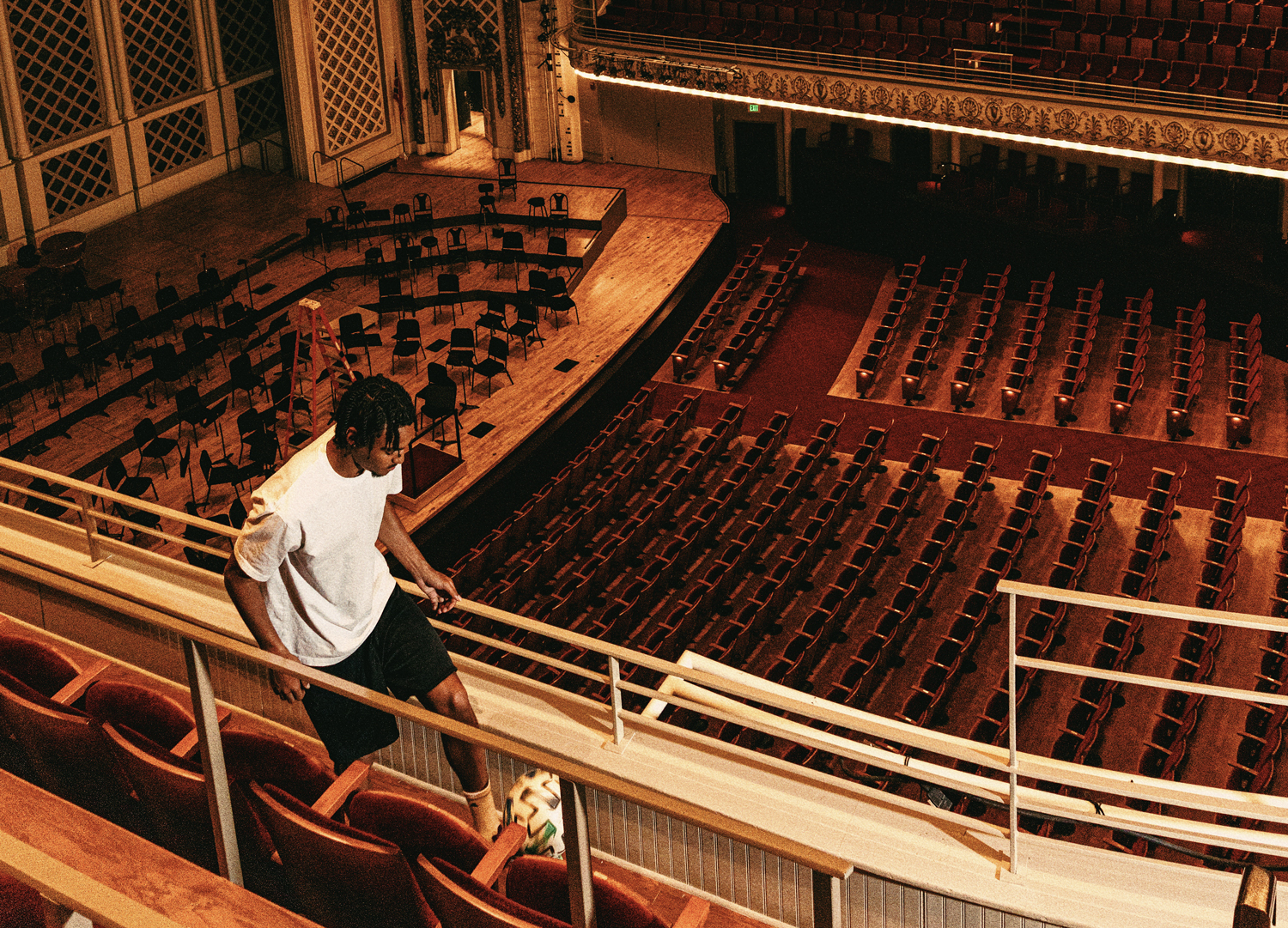 Kenji Mboma Dem juggles a soccer ball in an aisle of the balcony in Music Hall in Cincinnati.