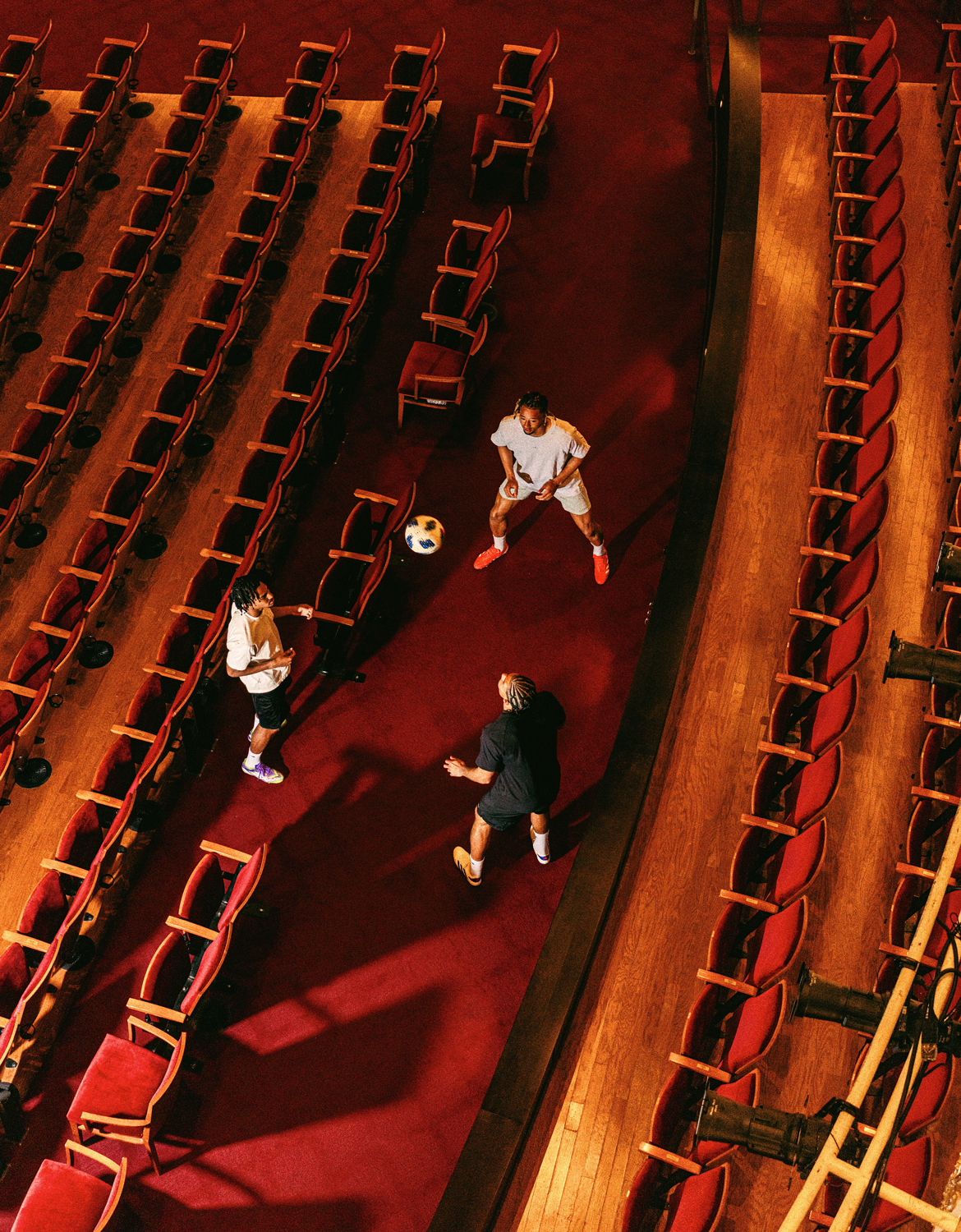 Kenji Mboma Dem (left), Miles Robinson (center) and Ayoub Jabbari (back) pass a soccer ball around in a triangular formation inside Music Hall in Cincinnati. 