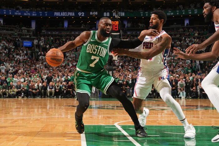 Jaylen Brown makes a move to the basket as a defender tries to stop him.