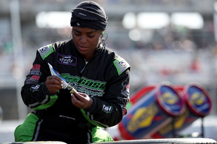 Joey Gase Motorsports pit crew member Brehanna Daniels prepares to change a tire during a race at Darlington Raceway on April 5, 2025, in Darlington, South Carolina. 