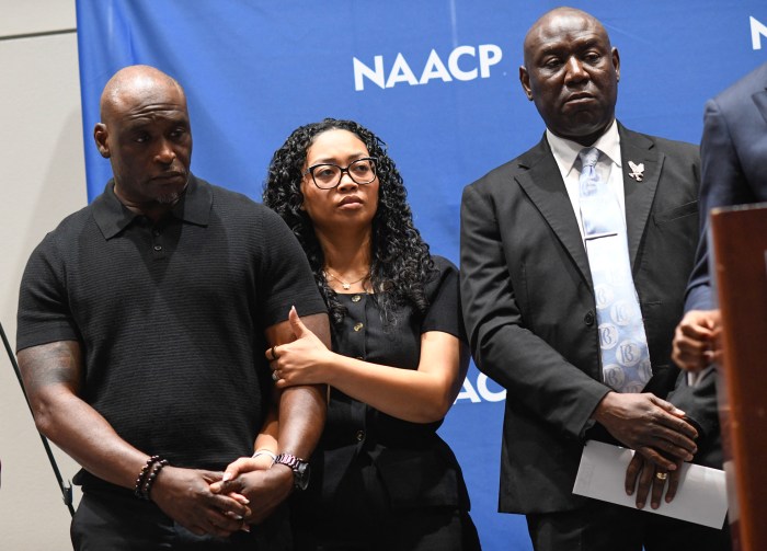 Elmore and Christine Wonsley stand with Ben Crump at a press conference.