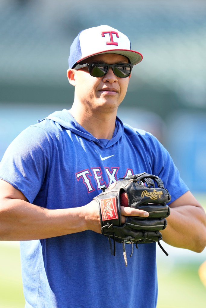 Will Venable holds his glove while watching Texas Rangers batting practice.