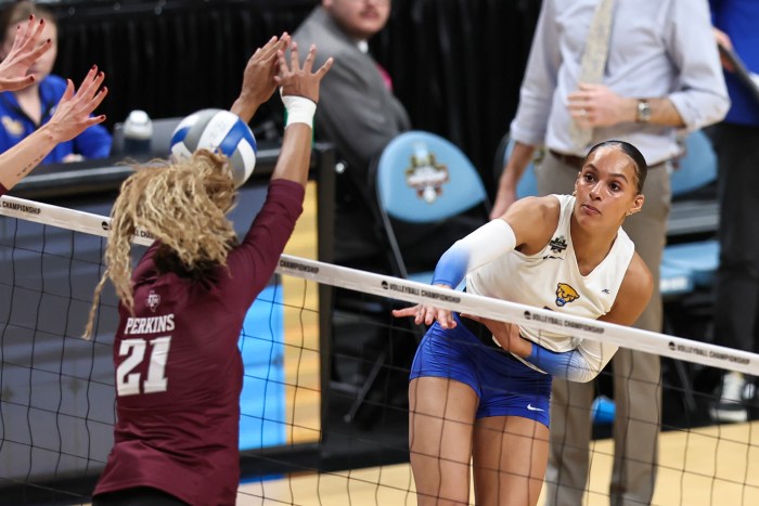 Pittsburgh's Olivia Babcock (right) spikes the ball off the head of Texas A&M's Morgan Perkins (left) during a semifinal match on Dec. 18, 2025, at T-Mobile Arena in Kansas City, Mo.