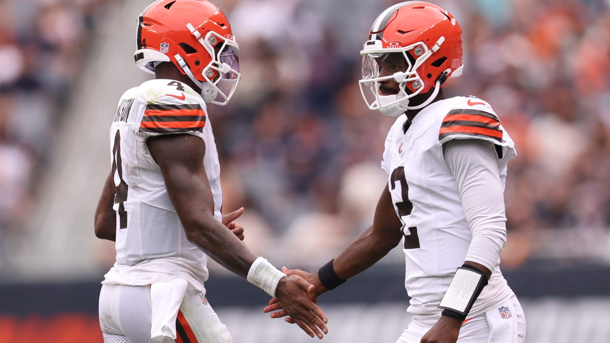 Shedeur Sanders high-fives teammate Deshaun Watson