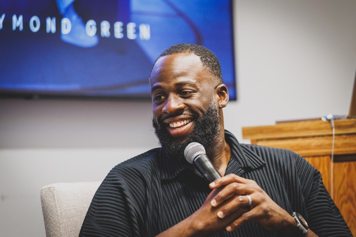Draymond Green holds a mic and gets interviewed during his docuseries.