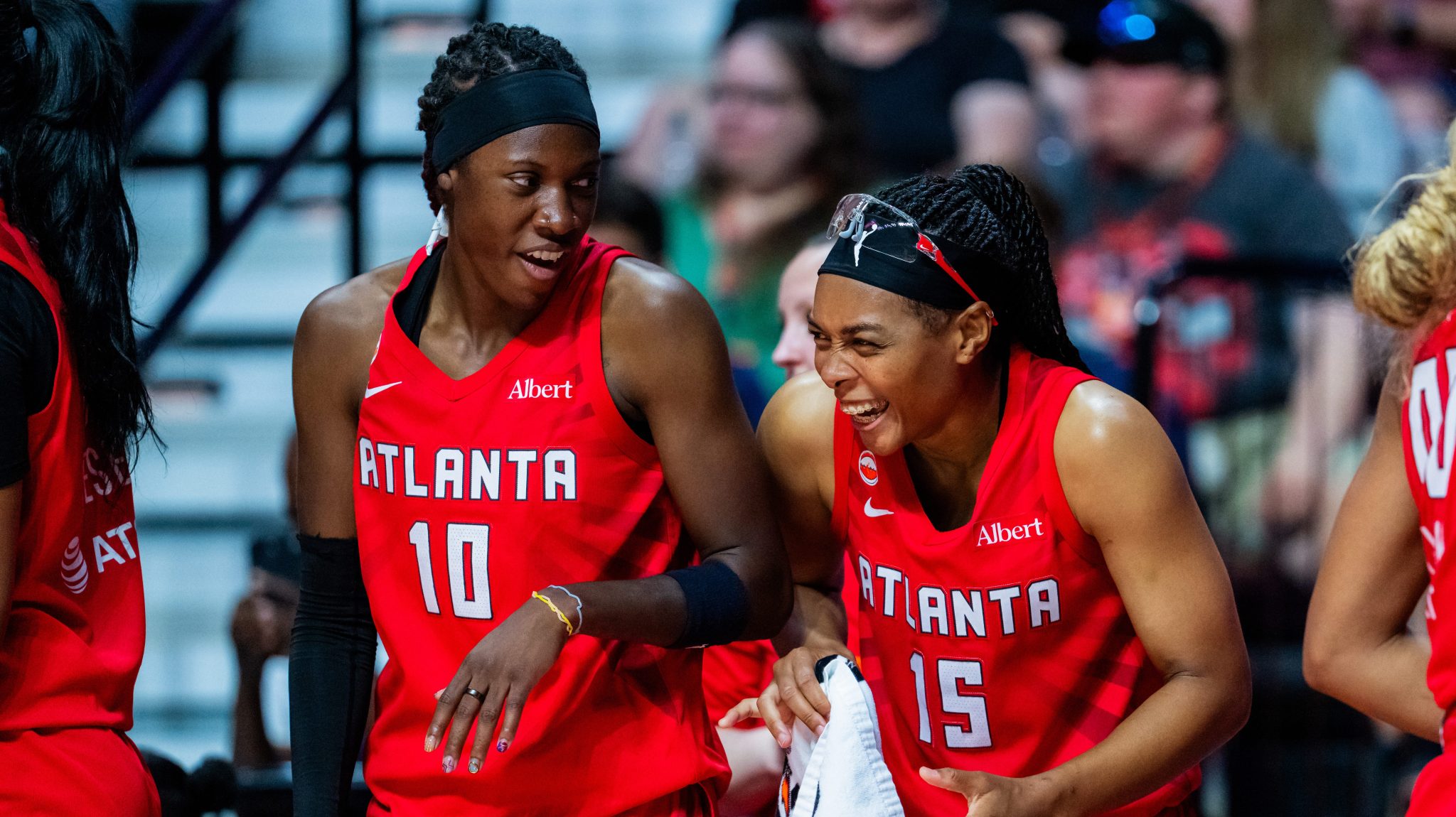 Atlanta Dream guards Rhyne Howard (left) and Allisha Gray (right) share a laugh during a game against the Connecticut Sun on Aug. 13, 2026, at Mohegan Sun Arena in Uncasville, Conn.