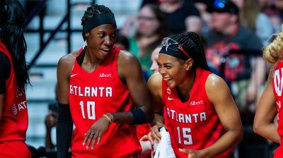 Atlanta Dream guards Rhyne Howard (left) and Allisha Gray (right) share a laugh during a game against the Connecticut Sun on Aug. 13, 2026, at Mohegan Sun Arena in Uncasville, Conn.
