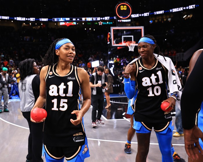Allisha Gray (left) and Rhyne Howard (right) grab rubber balls to throw to fans after a game on Sept. 19, 2026, at Gateway Center Arena at College Park in Atlanta.