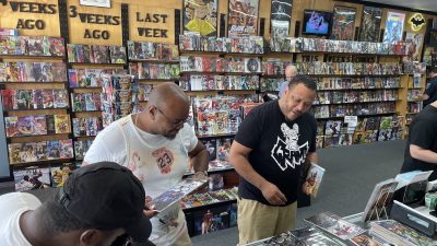 Customers browse comic books at Acme Comics