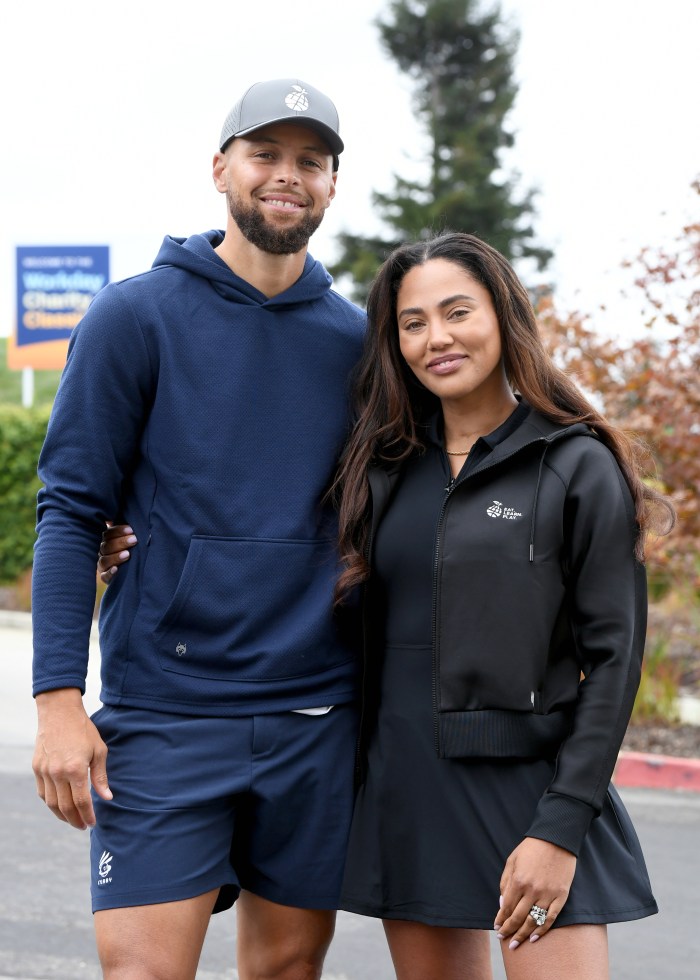 Stephen Curry and Ayesha Curry pose for a photo.