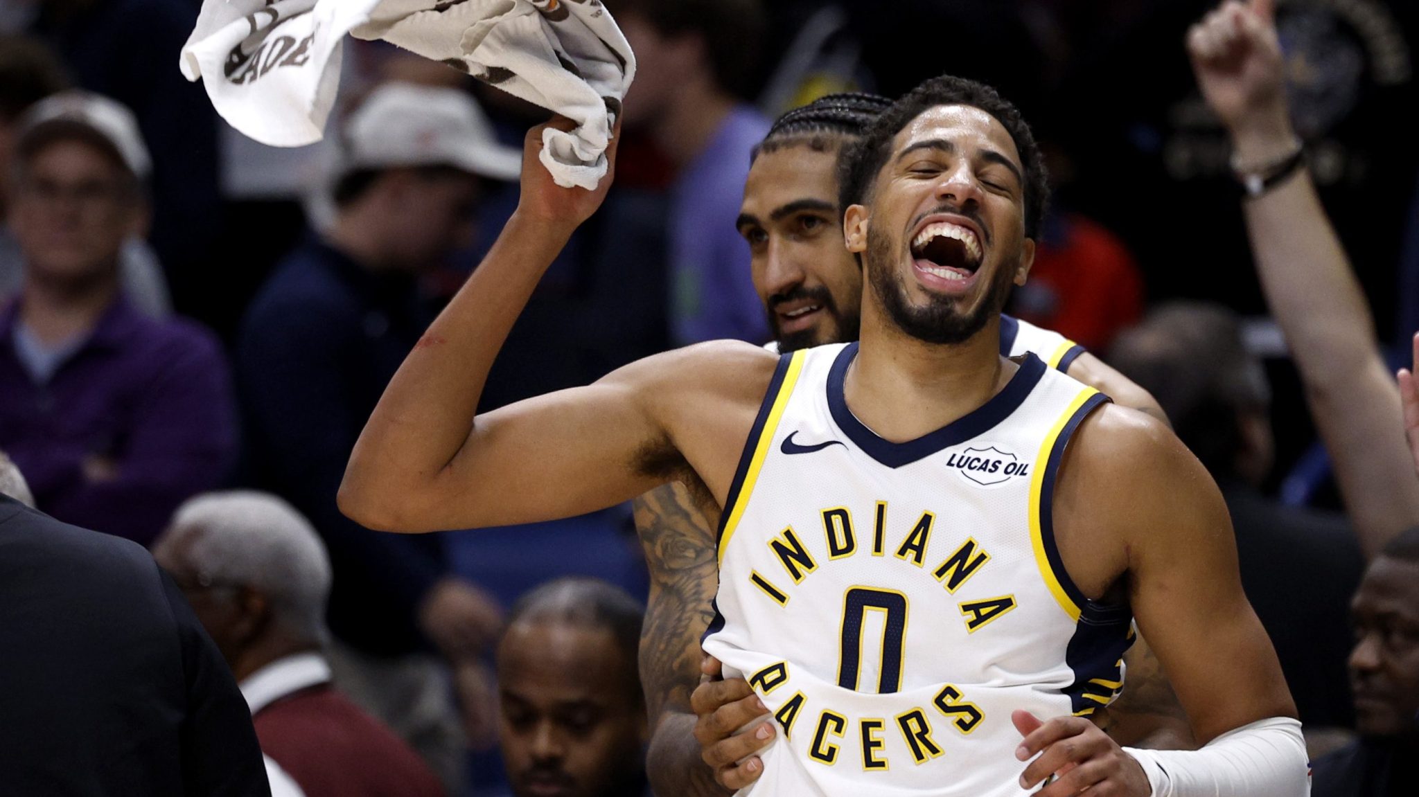 Tyrese Haliburton celebrates while holding up a towel.