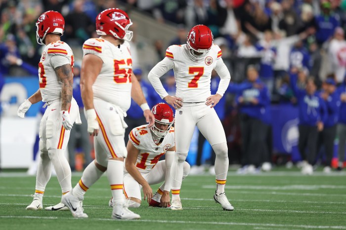 Harrison Butker looks down after missing a field goal
