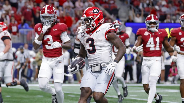 Nate Frazier runs for a touchdown as Alabama defenders chase after him.