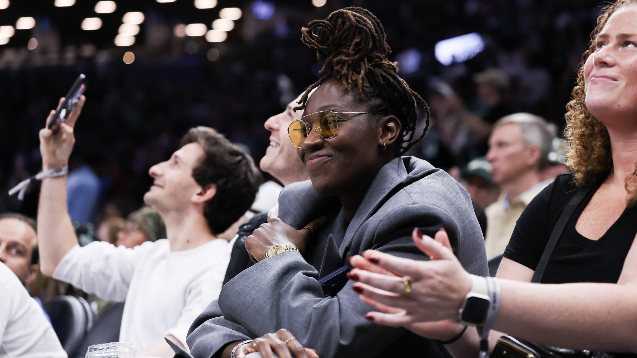 Former New York Liberty player Tina Charles watches the Liberty's game against the Minnesota Lynx during the first round of the WNBA playoffs on Sept. 29, 2026, at Barclays Center in Brooklyn, N.Y. T