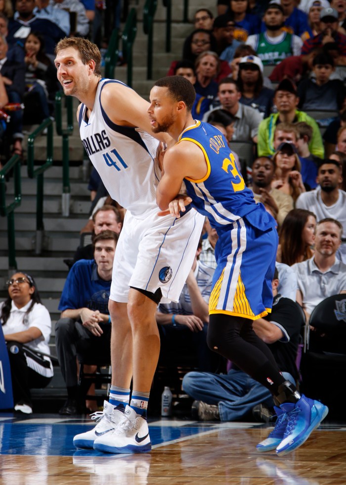 Dirk Nowitzki calls for the ball as Stephen Curry tries to defend him.